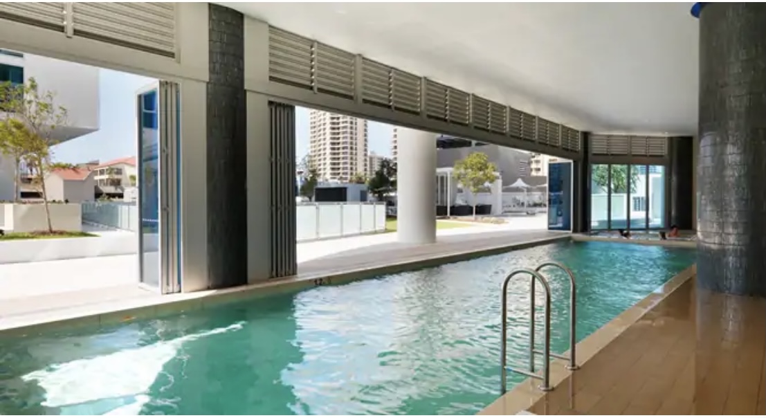 Indoor swimming pool with modern decor.